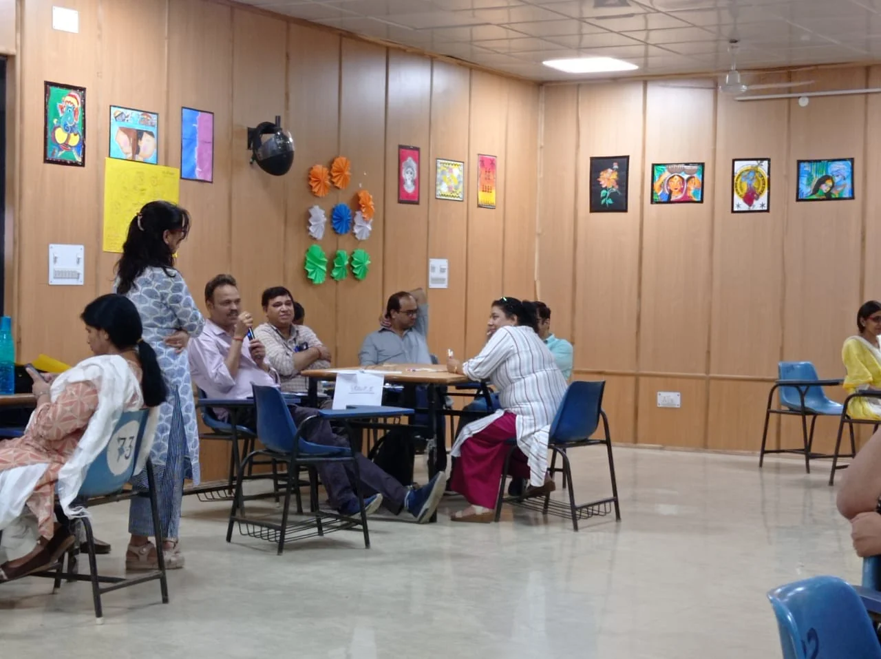 Teachers exchanging ideas around a classroom table